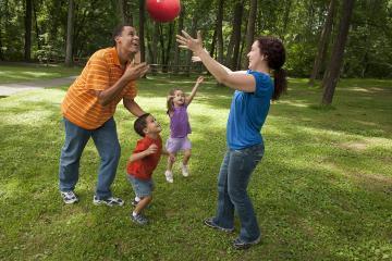Family playing outside with ball